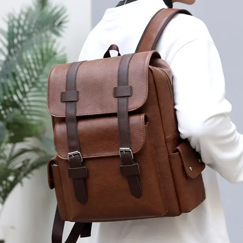 Person wearing a light brown vintage backpack in a clean, modern indoor setting