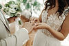 hands-ohands-newlyweds-with-wedding-rings-wedding-bouquet.jpg