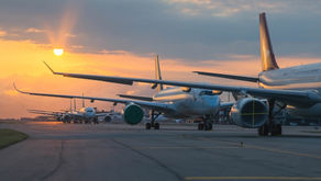 Planes on the runway at sunset