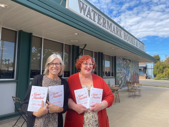 Jill and Sarah in front of Watermark Books with Never Finished book