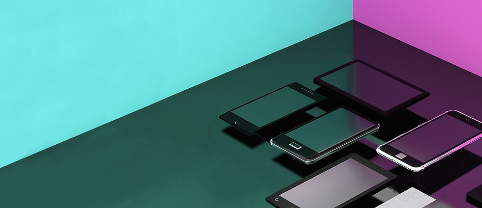 Photograph of some mobile devices on a table with multi colored RGB lights in the background.