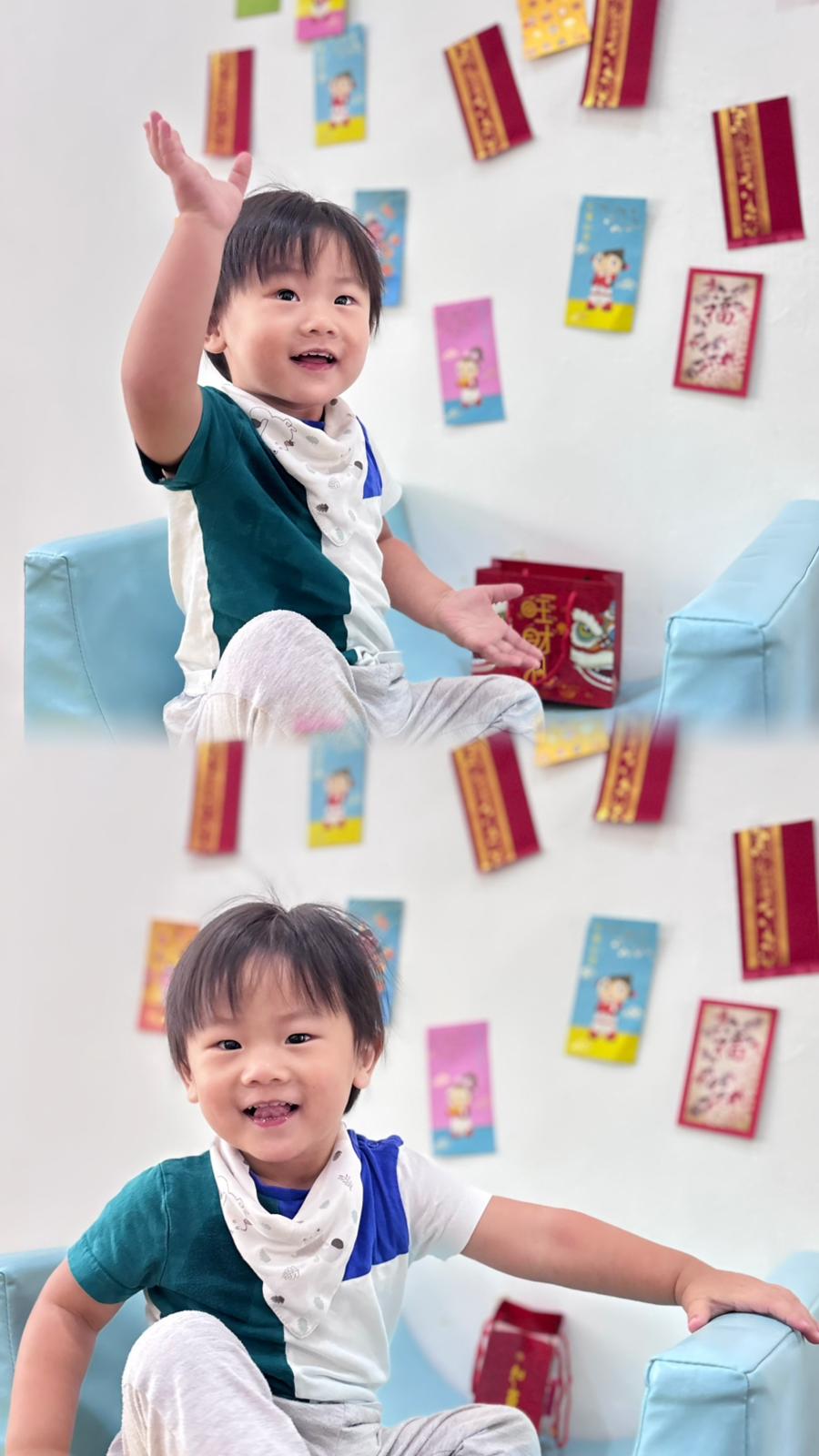 A cheerful toddler playing with red envelopes during a festive celebration.