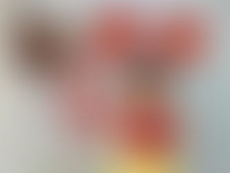 A child holding a red “Fu” sign for Lunar New Year celebration.