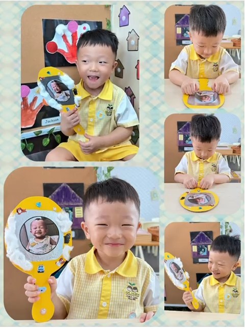 A happy child proudly shows a handmade photo craft in a classroom.