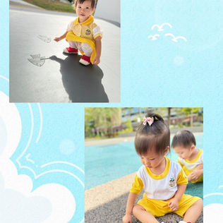 A toddler exploring a fish toy during outdoor play.