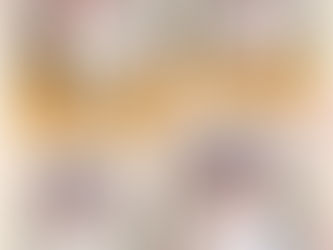 A happy baby exploring a cup and pencil.