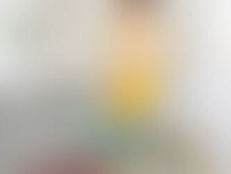 A toddler playing with colorful hoops and bean bags.