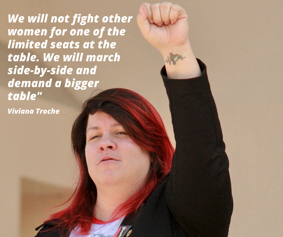 A photo of Viviana Troche with the quote "we will not fight other women for one of the limited seats at the table. We will march side-by-side and demand a bigger table"