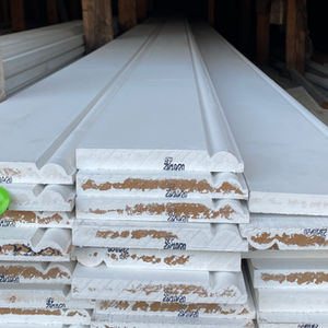 White baseboard moldings stacked, with 'Scan' text visible on packaging.