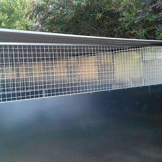 A metal enclosure with wire mesh on the upper half