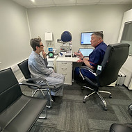 Consultation between a hearing specialist and a patient discussing tinnitus relief