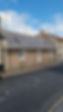 Bungalow with scaffolding along the front for roofing work