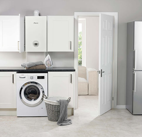 White Worcester Bosch boiler in a utility room above a washing machine and grey wicker laundry basket