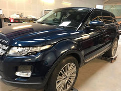 Dark blue Range Rover SUV inside a workshop