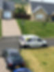 An aerial view of a white van with ‘A4 Decorating’ logo, a black car, and a blue car on a driveway
