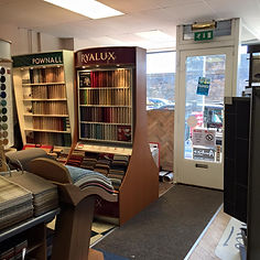 Interior of carpet store showing display stands with carpet samples
