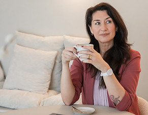 Business woman veerle bammens sipping a cup of coffee, looking to the left
