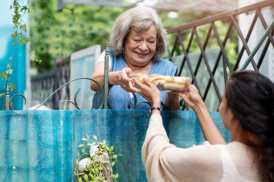 woman-offering-food-neighbor.jpg
