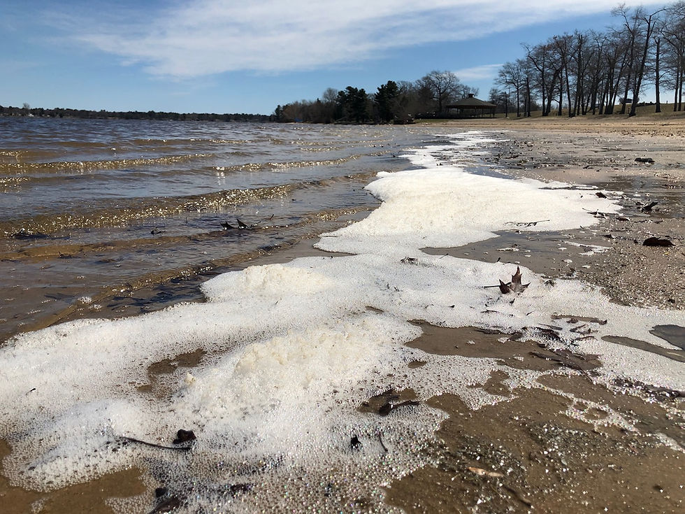 PFAS-laden foam accumulating on a contaminated shoreline