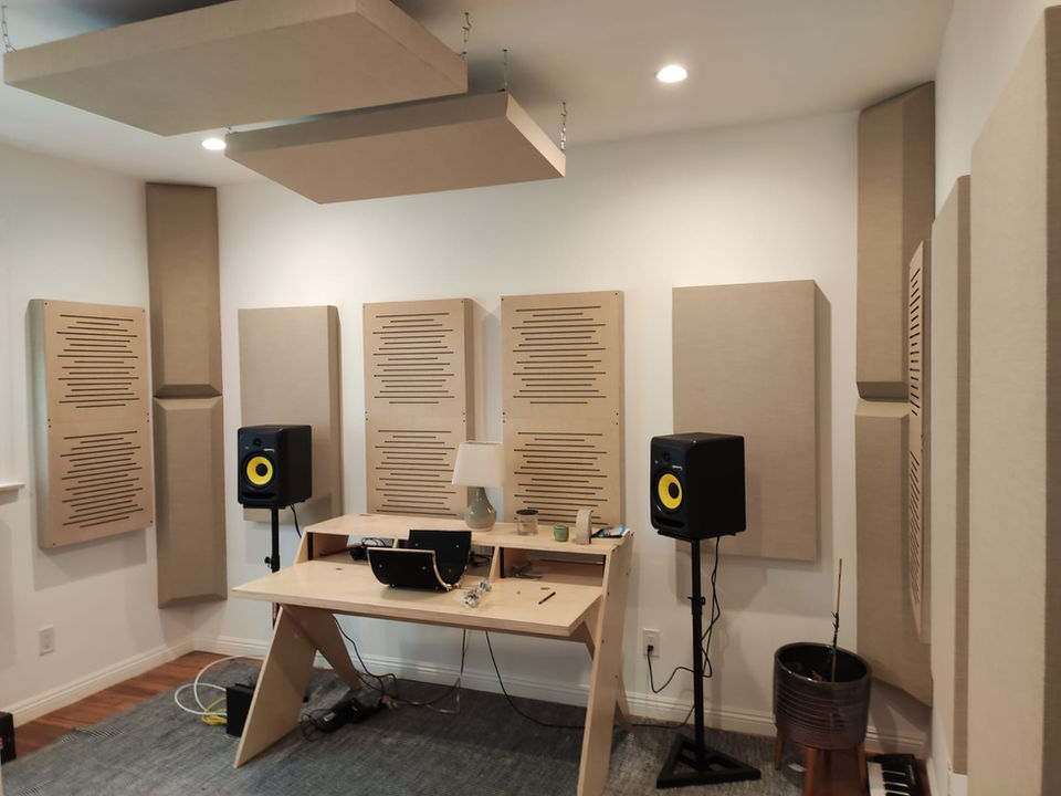 Office space with acoustic treatment including ceiling panels and wall panels