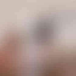 Mum exercising in background whilst baby crawls towards the camera