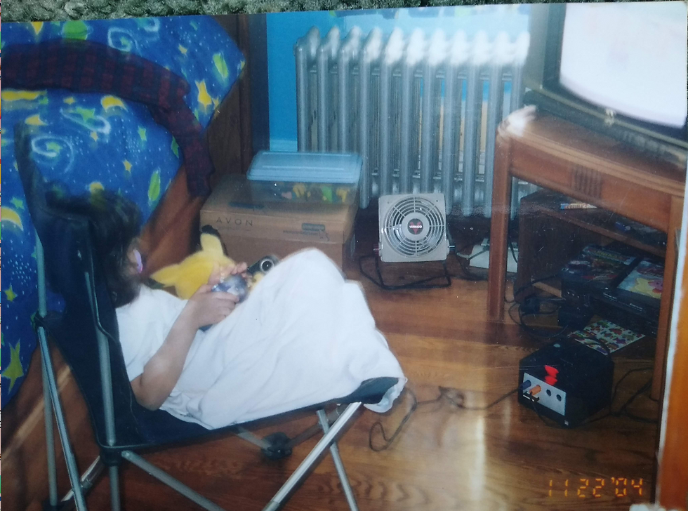 child sitting in lawn chair with pikachu playing gamecube