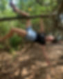 confident man hanging from a tree