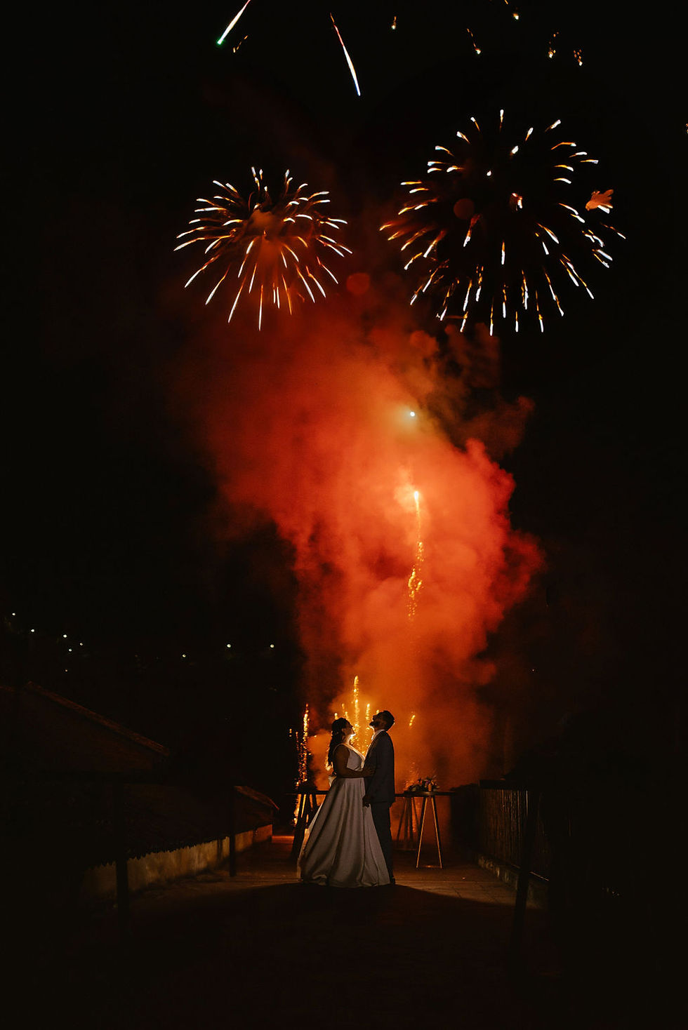 newly weds enjoying the Guatemala wedding traditions, meaning closing their wedding under a cloud of fireworks