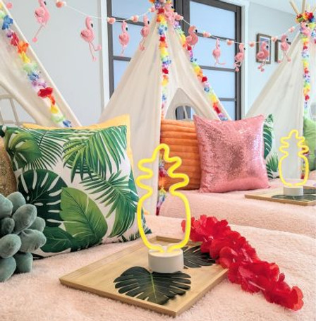 Tropical sleepover party theme with teepees and leaf pillows