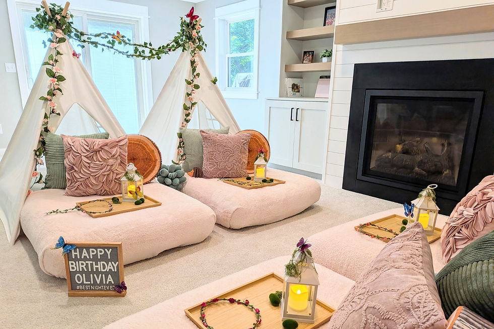 Four decorated white tents on plush beds with lanterns and pillows; sign reads Happy Birthday in a cozy party room.