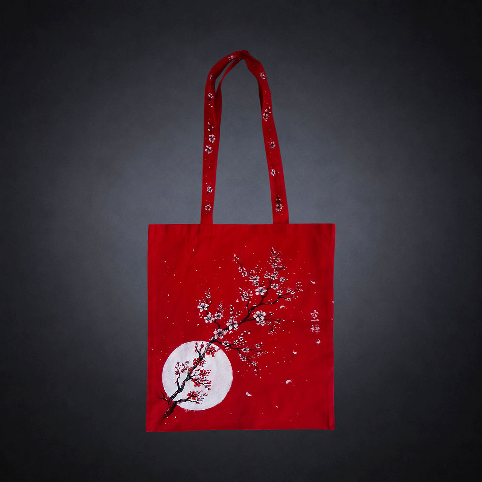 Luna de Cerezo, tote bag roja única pintada a mano por Kuzen Saha con una luna blanca y ramas de flores de cerezo.