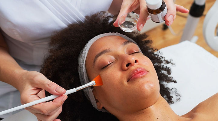 Close-up of a woman receiving a professional chemical peel treatment on her face, with a smooth and glowing skin result