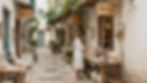 Charming street with shops, woman browsing pottery. Hotel and Area Gallery.