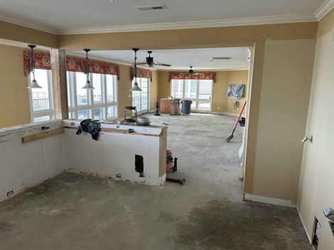 Kitchen and living room floor and walls before remodel.