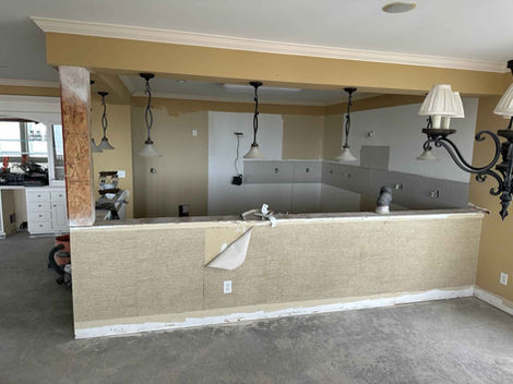 Kitchen before remodeling, dark mustard color.