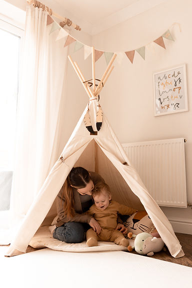Nanny in play tent with child