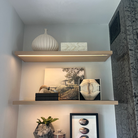 Custom wood built-in entertainment wall with integrated shelving and curated styling