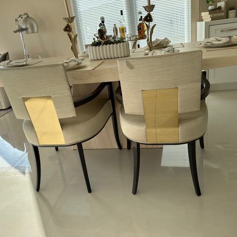 Accent seating with gold detail and neutral palette