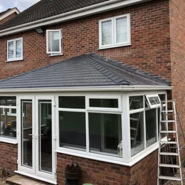Conservatory roof installation with white windows