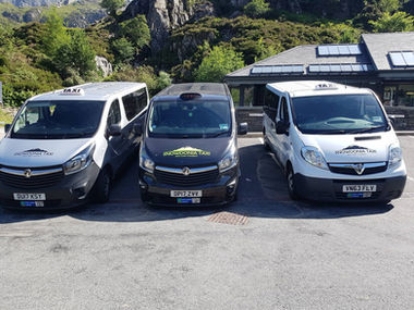 3 parked taxi vehicles