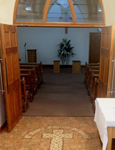 beautiful floor and wooden doors and rows of seats inside the funeral service