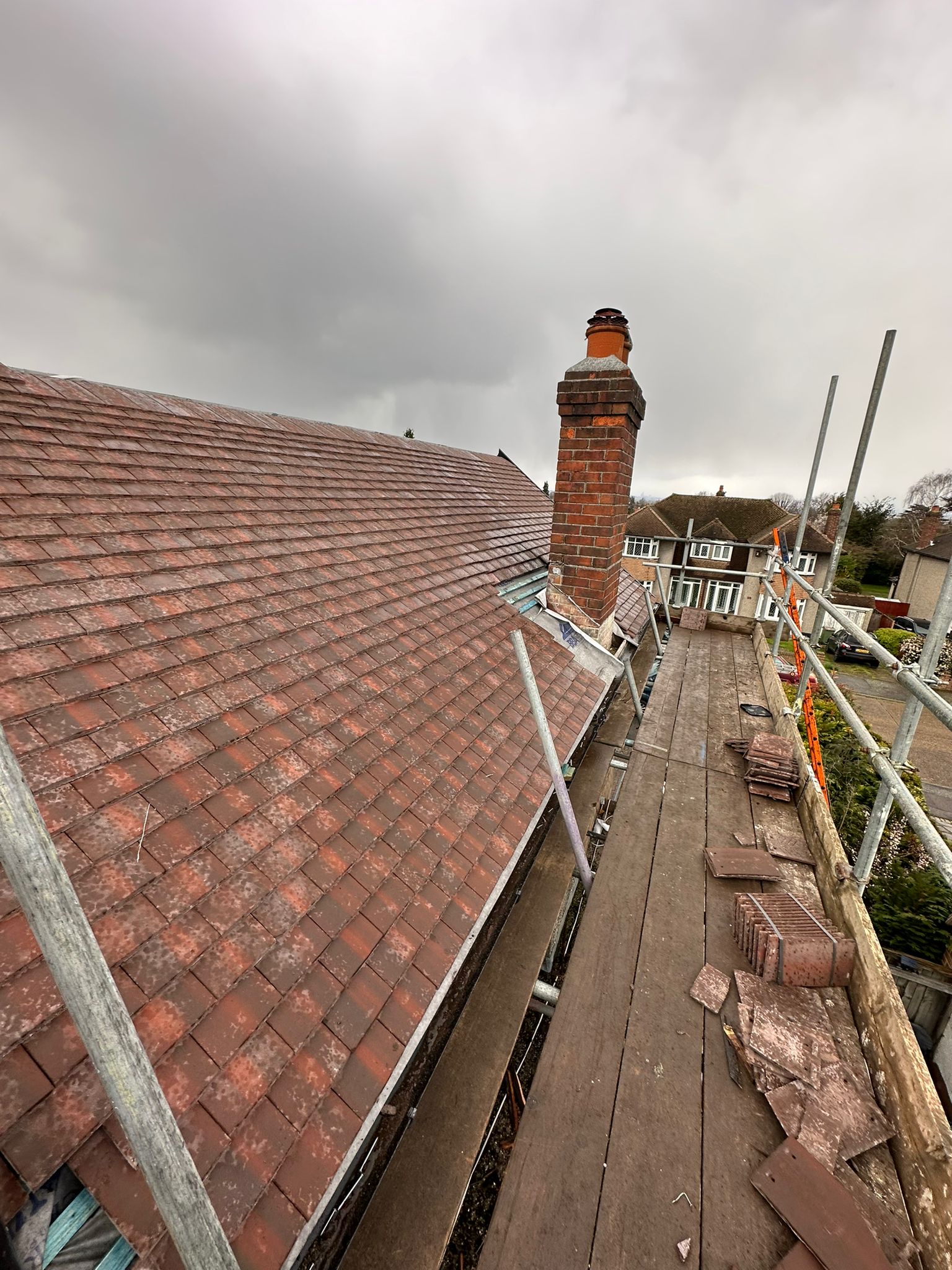 wh-roofing-red-tile-roof-installation-with-chimney-and-scaffold-13.jpeg