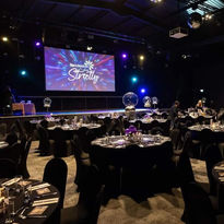 Balloons for a corporate event with black seating, tables and chairs