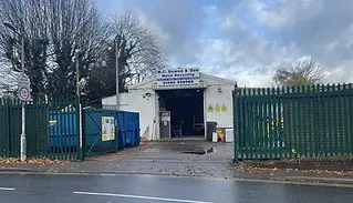 Scrap yard with green gates