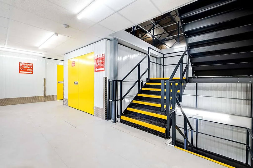 Storage area with yellow and black stairs at Spacebox in Birmingham