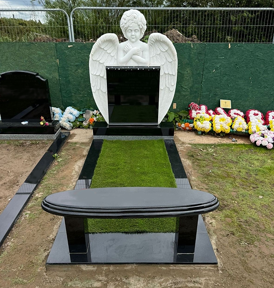 Gravestone surrounded by a selection of beautiful bright flowers
