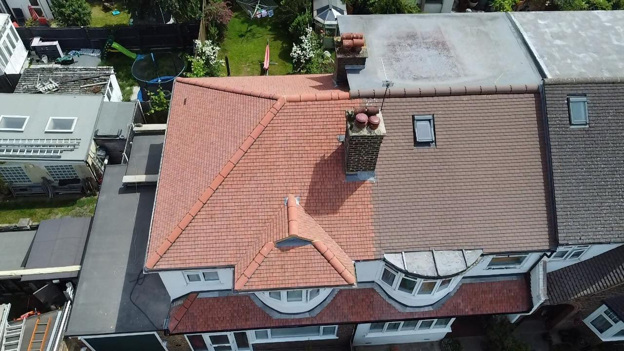 Completed red tiled house roof aerial view.