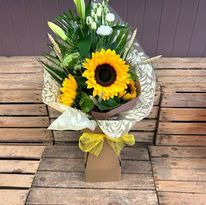 Summer themed flower bouquet with white lilies and sunflowers