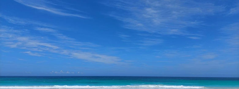 Strong Caribbean color palette and calm openness—high-impact for premium tourism positioning.