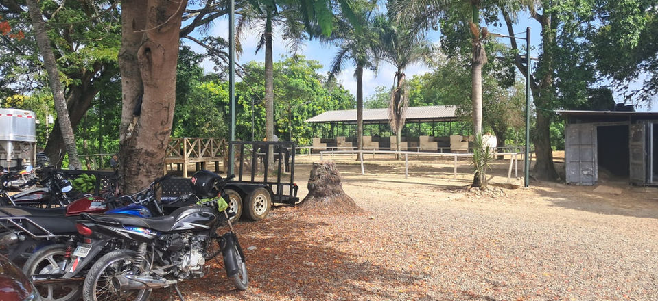 Operational area with horse transportation equipment, vehicles and access to the estate's riding facilities.